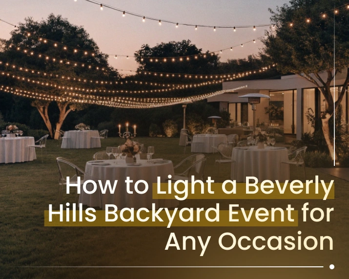 warm outdoor lighting illuminating a Beverly Hills backyard terrace at night with overhead string lights and path lights along stone walkways